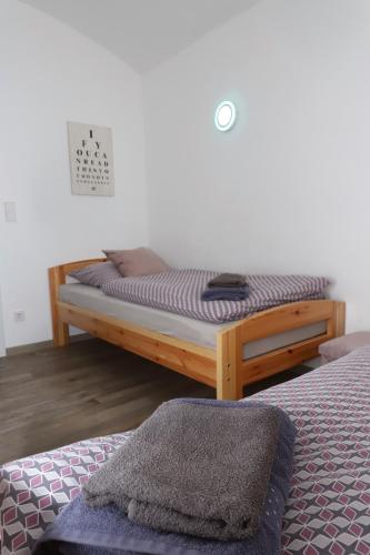 a bed with a wooden frame in a room at Gut Kuhfs in Großzössen