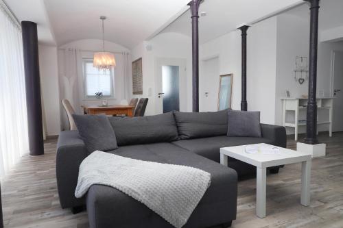 a living room with a couch and a table at Gut Kuhfs in Großzössen