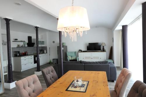 a living room with a table and a couch at Gut Kuhfs in Großzössen