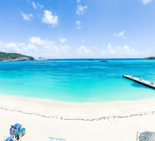 a view of a beach with a dock in the water at Sea Palace in Philipsburg