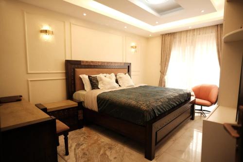 a hotel room with a bed and a window at CK luxury SuitesMuyenga in Kampala