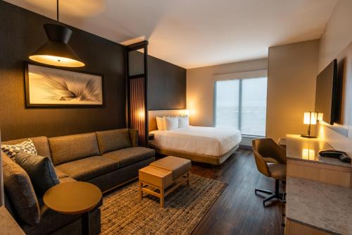a hotel room with a bed and a couch at Hyatt Place Eagle Pass in Eagle Pass