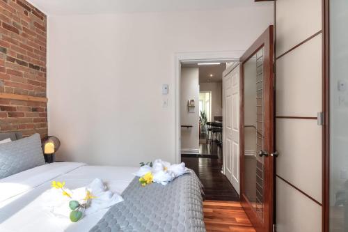 a bedroom with a bed with flowers on it at Fox Aparthotel Palais Des Congres VI in Montréal