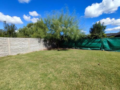 een grote tuin met een hek en een boom bij Casa quinta La Ruchi in San Andrés de Giles