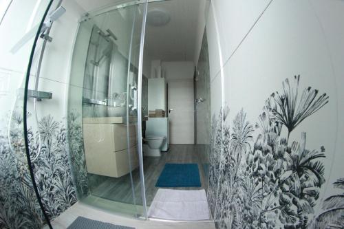 a bathroom with a glass shower with a toilet at Casa HELI 1 in San Zeno di Montagna