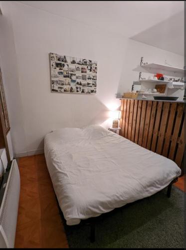 - une chambre avec un lit dans une pièce avec une photo sur le mur dans l'établissement Studio Évreux Centre Navarre, à Évreux