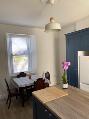a kitchen with a table and a table and a dining room at No1 The Townhouse Kildare in Kildare