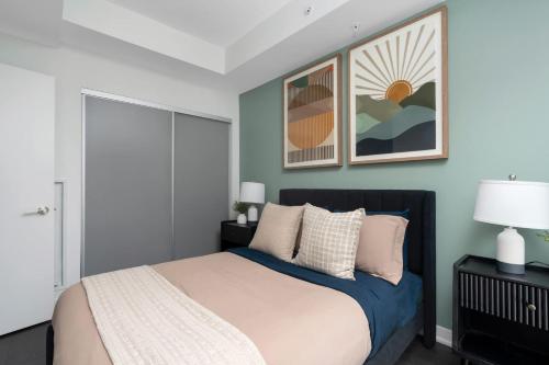 a bedroom with a bed with blue walls at 2BR 2BA Suite with Sofa Bed by Financial District in Toronto
