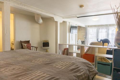 a bedroom with a large bed in a room at Modern lofty studio in Midtown / Charming Old SW in Reno