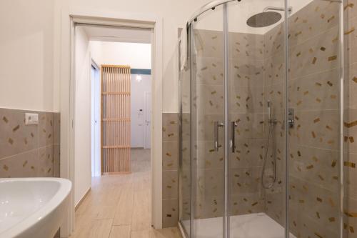 a bathroom with a shower and a tub at Relais Palazzo Nizza - Luxotel & Apartotel in Salerno