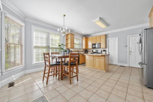 a kitchen with a table and chairs and a refrigerator at Family-friendly Ellenwood Home with Parking & Deck in Ellenwood
