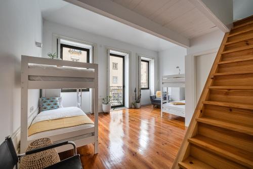 a bedroom with two bunk beds and a staircase at Hidden Gem near city center- garden, outdoor kitchen, sauna in Porto