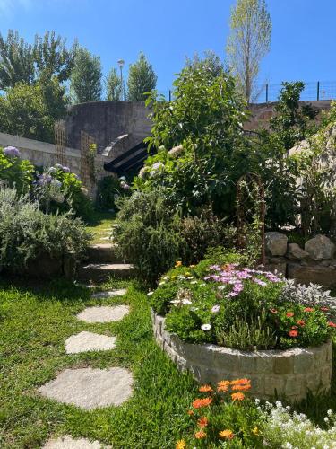 a garden with colorful flowers and a pathway at Hidden Gem near city center- garden, outdoor kitchen, sauna in Porto