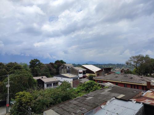 a group of houses in a town under a cloudy sky at Apartahotel JDK in Armenia