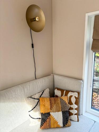 a living room with a couch with a lamp on the wall at Casa Mundo in Nunspeet