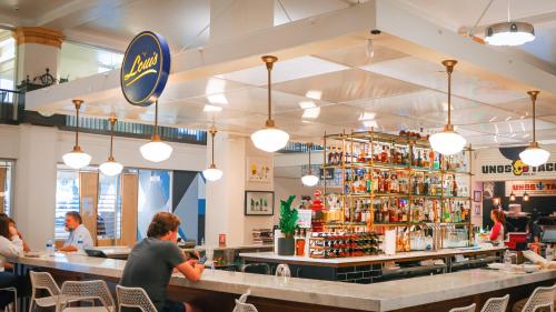 a restaurant with people sitting at a bar at Theatre Retreat 2 Bedroom Loft - 1 Blk from Theatres in Birmingham