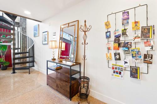 a hallway with a mirror on a wall with pictures at Theatre Retreat 2 Bedroom Loft - 1 Blk from Theatres in Birmingham