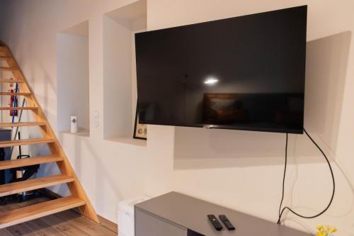 a flat screen tv hanging on a wall at Casa Nº7 - Vila d'Óbidos in Óbidos
