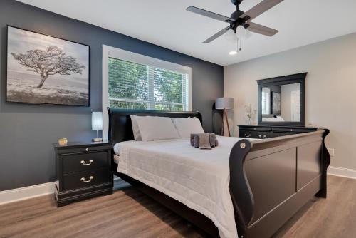 a bedroom with a bed and a ceiling fan at Spacious 4-bedroom Marietta Home w/ free parking in Marietta