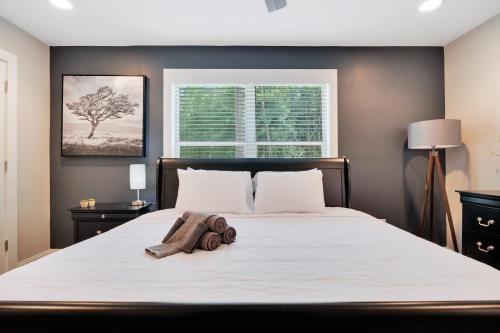 a bedroom with a large white bed with a window at Spacious 4-bedroom Marietta Home w/ free parking in Marietta