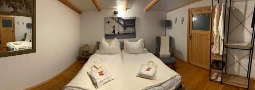 a bedroom with a bed with two towels on it at La Maison Pritzwalk - Bett & Bike in Pritzwalk