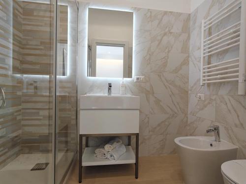 a bathroom with a sink and a mirror and a tub at La Casa di MiDa in Rome