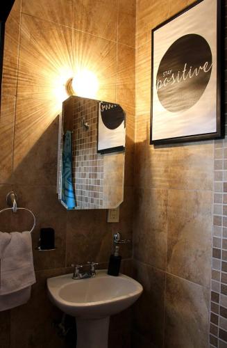 a small bathroom with a sink and a light at Casa de Huéspedes en Satélite - Boutique Rosas in Mexico City