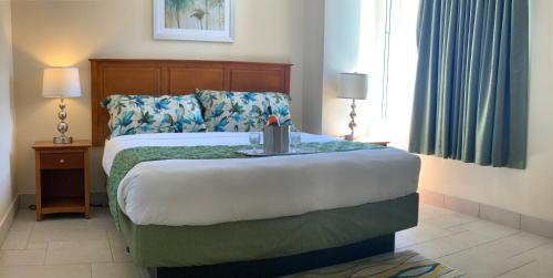a bedroom with a bed with a table on it at Sea Palace in Philipsburg