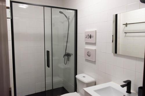 a bathroom with a shower and a toilet and a sink at Casa Nº11 - Vila d'Óbidos in Óbidos