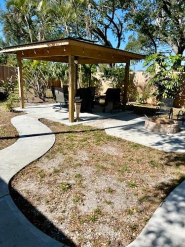 a gazebo with a table and chairs in a yard at The Beach House Escape in Bradenton