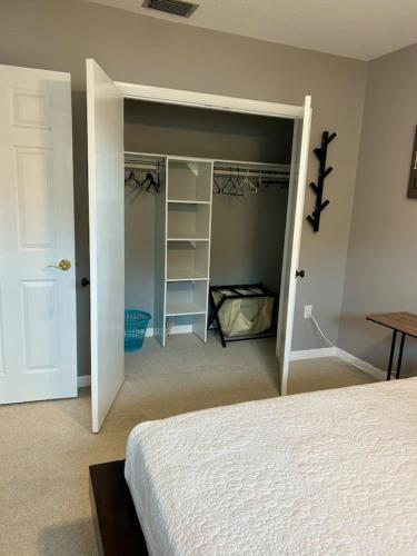 a bedroom with a bed and a closet at The Beach House Escape in Bradenton