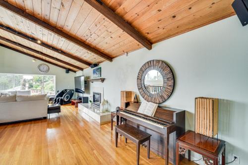 a living room with a piano and a couch at Aptos Home with Decks and Hot Tub - 2 Mi to Beach! in Aptos