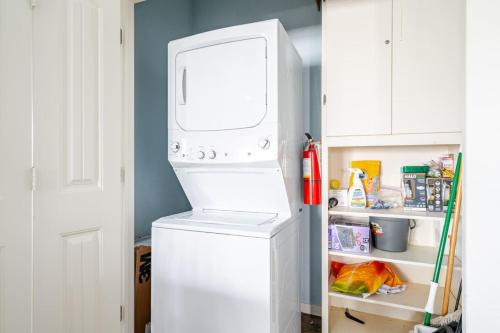 a white refrigerator with its door open in a kitchen at Central 2BR 2BA Easy Beach Access Sleeps 10 in Bolivar Peninsula