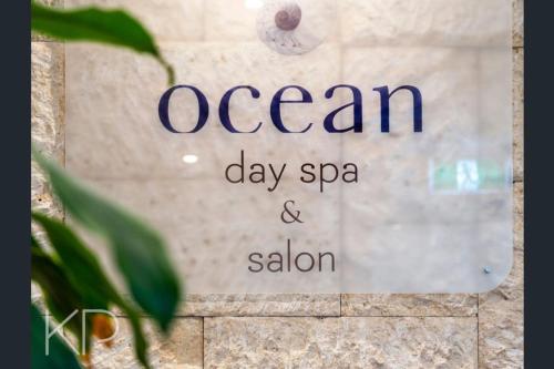 a sign that reads ocean day spa and salon at Bright Oceanview Apartment on Level 11, Mantra on View, Surfers Paradise in Gold Coast