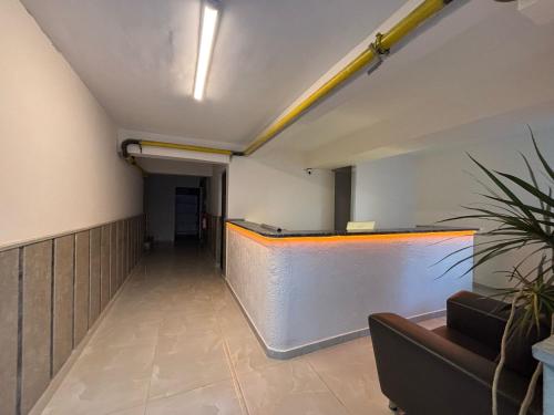 an empty hallway in an office with a couch at Zeus Suit Görükle in Nilüfer