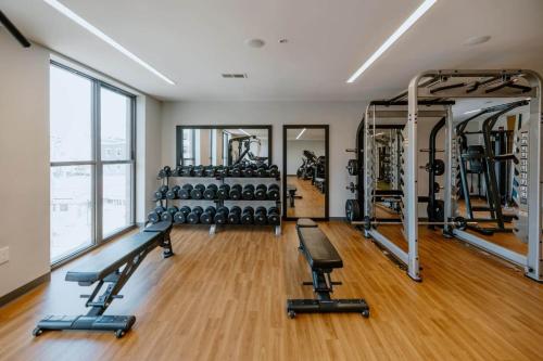 a gym with lots of treadmills and machines at OTR 1 Bed Suite Free Parking Gym Pool Clubroom in Cincinnati