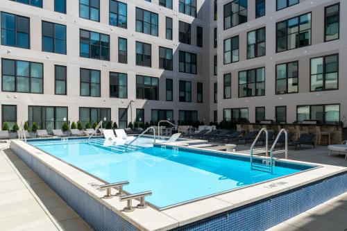 a swimming pool in front of a building at OTR 1 Bed Suite Free Parking Gym Pool Clubroom in Cincinnati