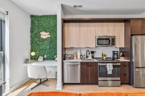 a kitchen with wooden cabinets and stainless steel appliances at OTR King Bed Free Parking Gym Top Floor Club Room in Cincinnati