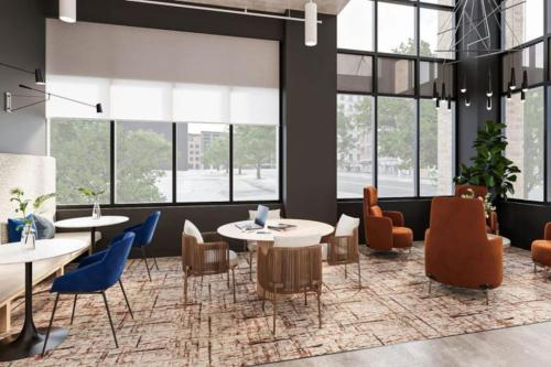 a lobby with tables and chairs and windows at OTR King Bed Free Parking Gym Top Floor Club Room in Cincinnati