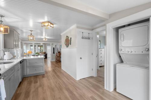 a large kitchen with white cabinets and a large window at 35 - Beautiful 3 BR Beach Haven in Old Lyme