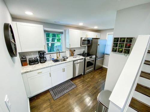 a kitchen with white cabinets and stainless steel appliances at 21 COMFORTABLE AND LUXURIOUS in Plainville