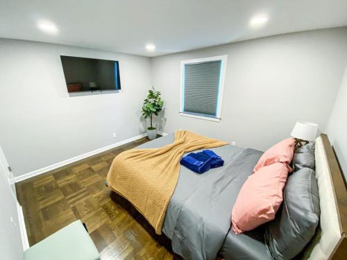 a bedroom with a bed and a flat screen tv at 21 COMFORTABLE AND LUXURIOUS in Plainville