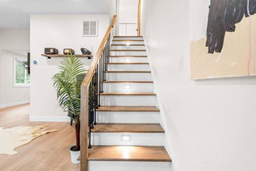 a staircase in a home with white walls and wooden floors at 37 - Luxury Collection in Stratford