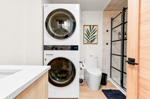 a washer and dryer in a white kitchen with a sink at 37 - Luxury Collection in Stratford