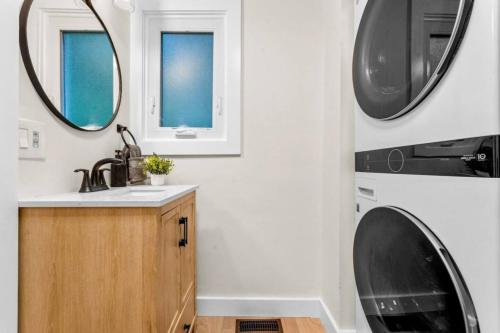a bathroom with a sink and a washing machine at 37 - Luxury Collection in Stratford