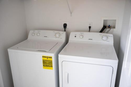 two white appliances in a small kitchen with a washer and dryer at 3 FRESHLY REDONE NEWLY FURNISHED A MUST SEE in Plainville