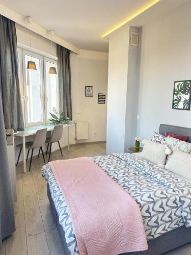 a bedroom with a bed and a table with chairs at Exclusive Apartments Smolna in Warsaw