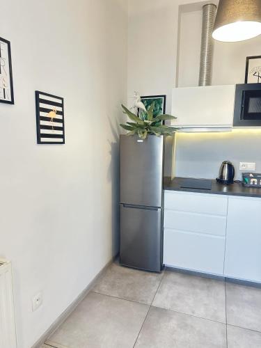 a kitchen with a stainless steel refrigerator in a room at Exclusive Apartments Smolna in Warsaw