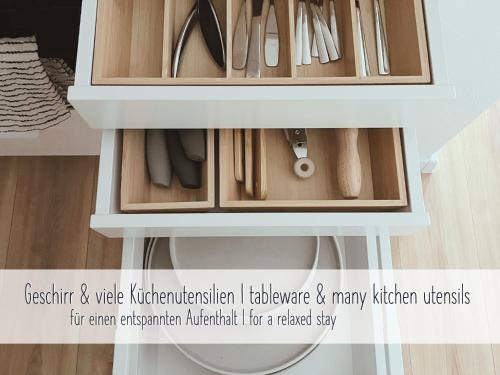 a drawer in a cabinet with many kitchen utensils at ApartNaest Radeberg - vollausgestattete 1 - 4 Zimmer Apartments I 24h flexibler mobiler Check-in via Link I Parkplatz auf Anfrage I Platz für bis zu 60 Personen in Radeberg