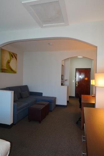 a living room with a couch and a table at Comfort Suites Bush Intercontinental Airport in Houston